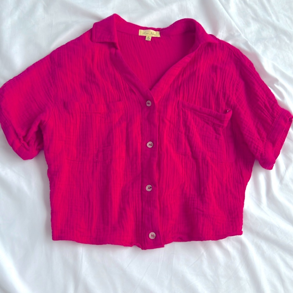 Hot pink women size S shirt with buttons that can be undone.